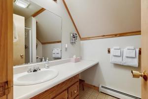a bathroom with a sink and a mirror at North Hill Cabin in Jay +48 photos