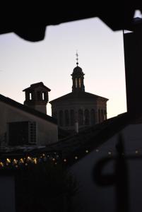 a view of a building with a church in the background at La Terrazza in Centro in Treviglio +33 photos