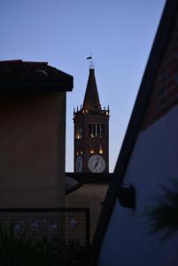 a clock tower with lights on top of it at La Terrazza in Centro in Treviglio