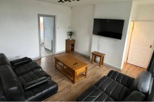 a living room with a couch and a coffee table at 3 Bed House Sleeps 5 - Free Parking - Tv & WiFi in Sheffield