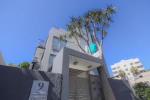 a building with a palm tree in front of it at Atlantic Affair Boutique Hotel in Cape Town