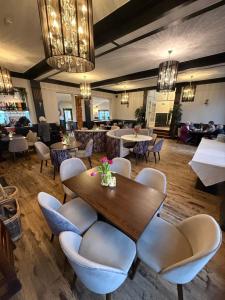 a restaurant with a table and chairs and a bar at The Lilly Restaurant With Rooms in Llandudno