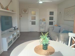 a living room with a table and a couch at ROYAL BEACH - Appartment with sea view & terrace in Faro de Cullera