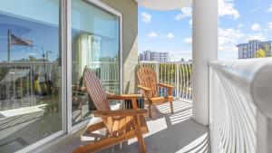 two chairs on a balcony with a view of the city at August Beach Escape Special Rates Available! in St. Pete Beach