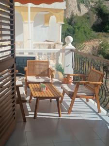 a patio with two chairs and a table on a balcony at ROYAL BEACH - Appartment with sea view & terrace in Faro de Cullera