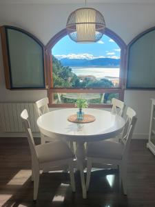 a white table and chairs in a room with a large window at ROYAL BEACH - Appartment with sea view & terrace in Faro de Cullera +65 photos