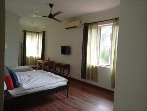 a bedroom with a bed and a window at Rumah Putih B&B Sepang - KLIA 1&2 in Sepang