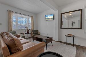 a living room with a couch and a table at Housepitality - The Southside Ranch in Columbus