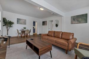 a living room with a couch and a table at Housepitality - The Southside Ranch in Columbus