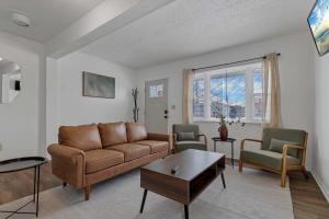 a living room with a couch and two chairs at Housepitality - The Southside Ranch in Columbus