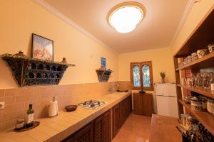 a kitchen with a sink and a stove in it at Casa Panorama in Chefchaouen +46 photos