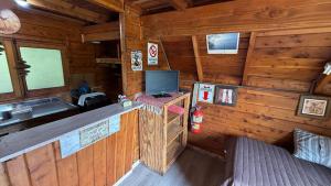 a cabin with a desk with a computer in it at Complejo Aiken in Villa Traful