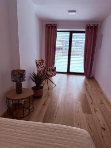a living room with a bed and a large window at Villa Vita - GLORIA in Slovenj Gradec