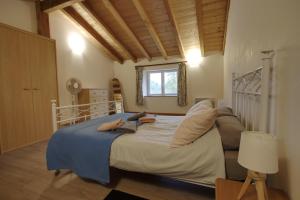 a bedroom with a bed with two people laying on it at Gîtes de Peyrounou in Lacapelle-Biron +46 photos