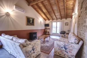 a living room with two couches and a fireplace at Gîtes de Peyrounou in Lacapelle-Biron