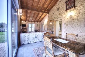 a living room with a table and chairs at Gîtes de Peyrounou in Lacapelle-Biron