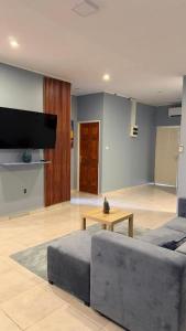 a living room with a couch and a table at ELY'S Appartment #1 in Paramaribo