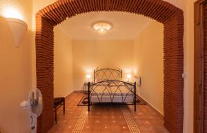 a bedroom with a bed in a room with a brick wall at Casa Panorama in Chefchaouen