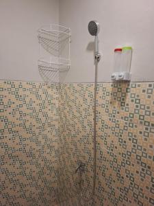 a bathroom with a shower with a shower head at Waceno Umma in Ruteng