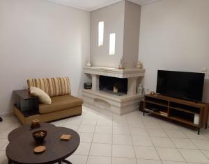 a living room with a television and a fireplace at Marbi Apartment in Tripoli