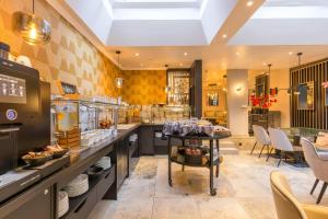 a large kitchen with a table and chairs at Leonardo Hotel Antwerp The Plaza in Antwerp +164 photos