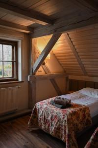 an attic bedroom with a bed in a room at Pałac Brzeźno Spa & Golf in Oborniki Śląskie +54 photos