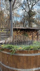 a wooden fence with a garden in front of a building at Penates Aparthotel in Koropovo +18 photos