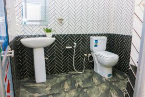 a bathroom with a toilet and a sink at Ivy Cottage- Midigama in Midigama East +17 photos