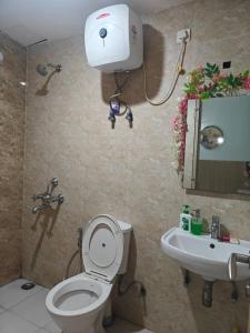 a bathroom with a toilet and a sink at Shivaya Homes in Chhatikara +18 photos