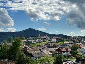 a town with houses and a blue sky with clouds at Landhaus Meine Auszeit in Bodenmais