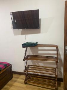 a tv on top of a shelf in a room at The Ceylon Olive Resort in Katunayaka +15 photos