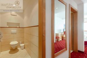 a bathroom with a toilet and a room at Sporthotel Christophorus in Kappl +28 photos