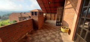 an outside hallway of a house with a brick wall at Zirahuén 6 personas in Zirahuén