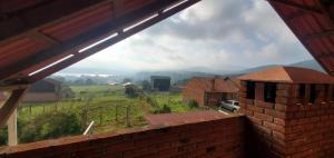 a view of a farm from a brick house at Zirahuén 6 personas in Zirahuén