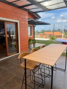a wooden table and chairs on a patio at Refúgio no Campo in Mairinque
