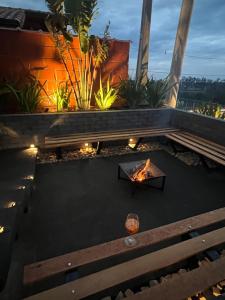 an outdoor patio with a table and a fire pit at Refúgio no Campo in Mairinque
