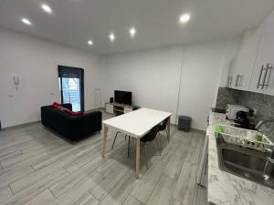 a kitchen with a table and a couch in a room at CASA ANALUCIA in Faro