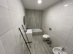 a white bathroom with a toilet and a sink at CASA ANALUCIA in Faro