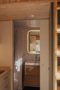 a small bathroom with a sink and a mirror at HolaCamp la Franca in Las Conchas