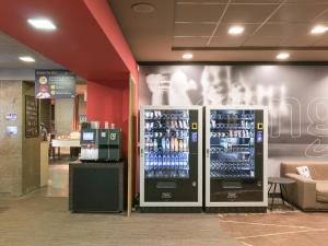two vending machines in a store with drinks at a&o Hostel Milano Ca Granda in Milan