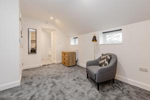 a living room with a chair and a window at Studio Room, Parking, Contractors and Relocators, Weekly Deals in Maidstone