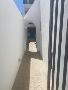a hallway of a white building with an open door at CASA ANALUCIA in Faro
