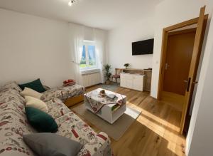 a living room with a couch and a table at Apartment Weisswand in Colle Isarco