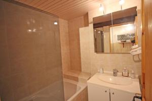 a bathroom with a shower and a sink and a tub at Les tuilières in Masléon +12 photos