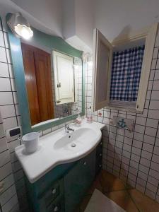 a bathroom with a sink and a mirror at Milion's House Apartments in Minori +20 photos