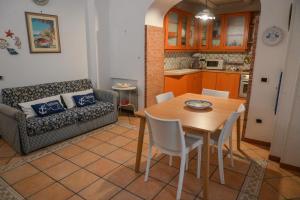 a living room with a table and a couch at Milion's House Apartments in Minori