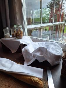 a table with a napkin and bread on a table with a window at Gränna Strandhotell in Gränna +95 photos