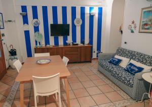 a living room with a couch and a table at Milion's House Apartments in Minori