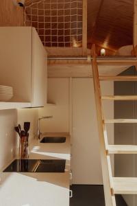 a kitchen with a loft bed and a sink at HolaCamp la Franca in Las Conchas