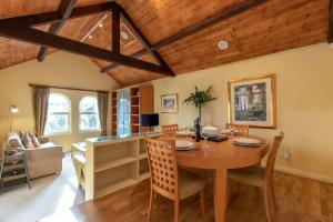 a dining room and living room with a table and chairs at Underscar - Luxury 1 Bed Apartment in Applethwaite